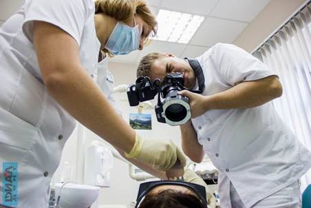 Стоматолог Центра "Диал-Дент" делает фотосъемку зубов пациента